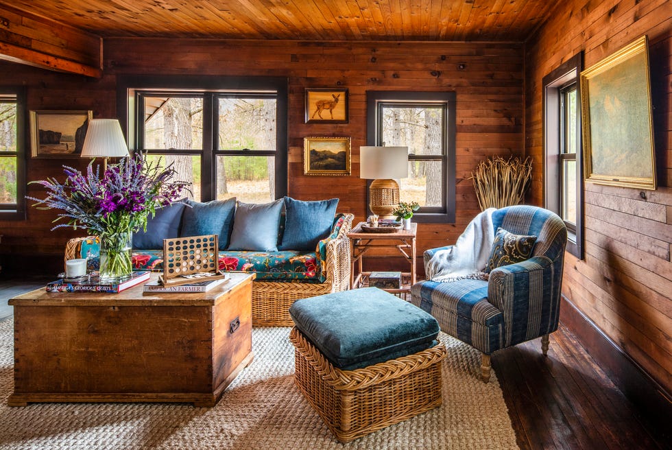 rustic farmhouse living room with wood walls and blue upholstery