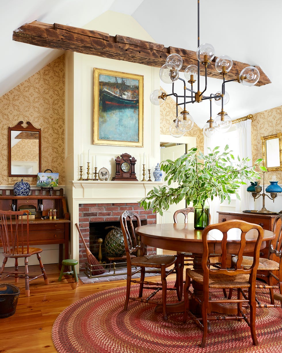 Groggy Anchor Cape Cod Cottage Dining Room cape cod style dining room with timber beams and a cream painted wood fireplace mantel