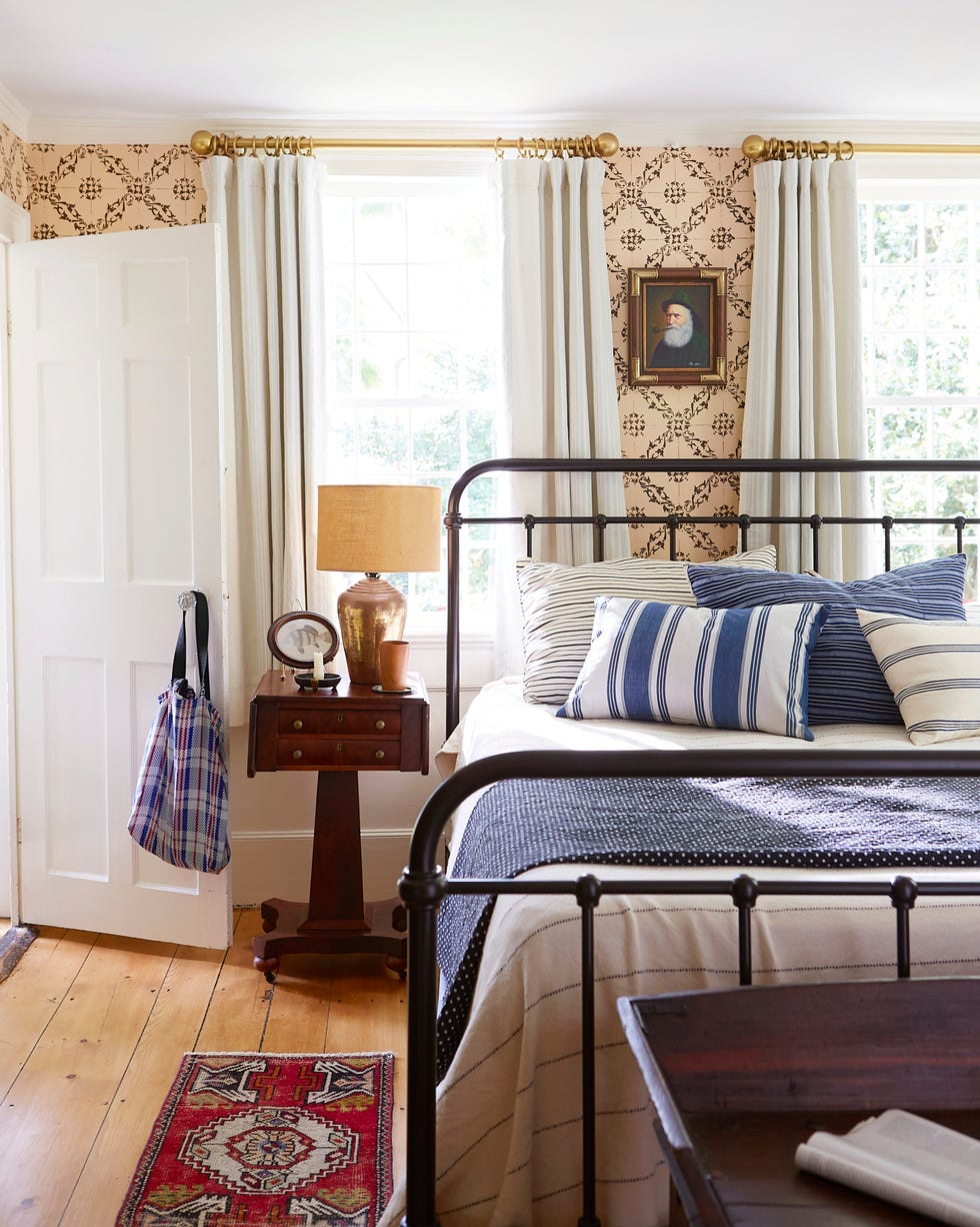 Groggy Anchor Cape Cod Cottage Bedroom home of steve ballerini and colin bohrer, one of the oldest cape cottages in provincetown, massachusetts cape cod cottage, cape cod style home bedroom with varied width floorboards