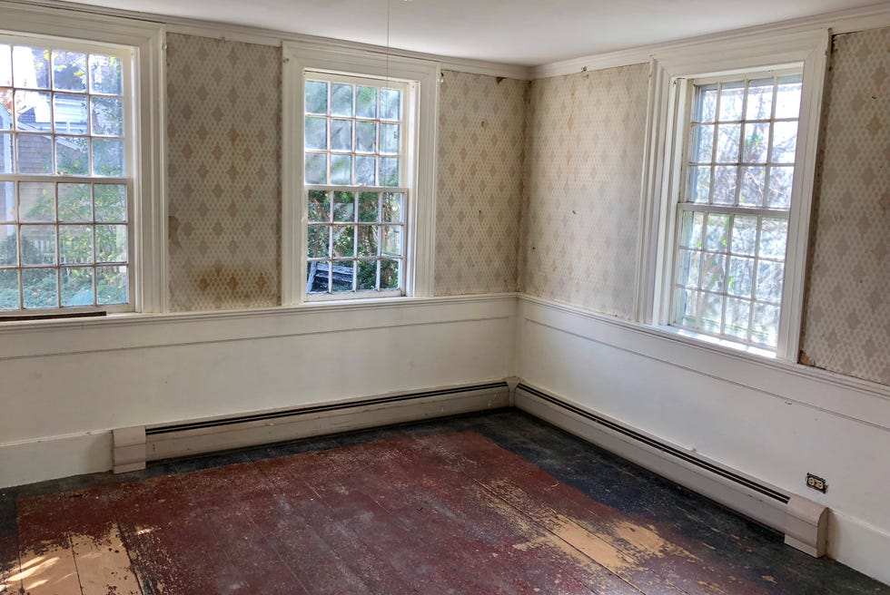 a room with windows and a wood floor a room with windows and a wood floor