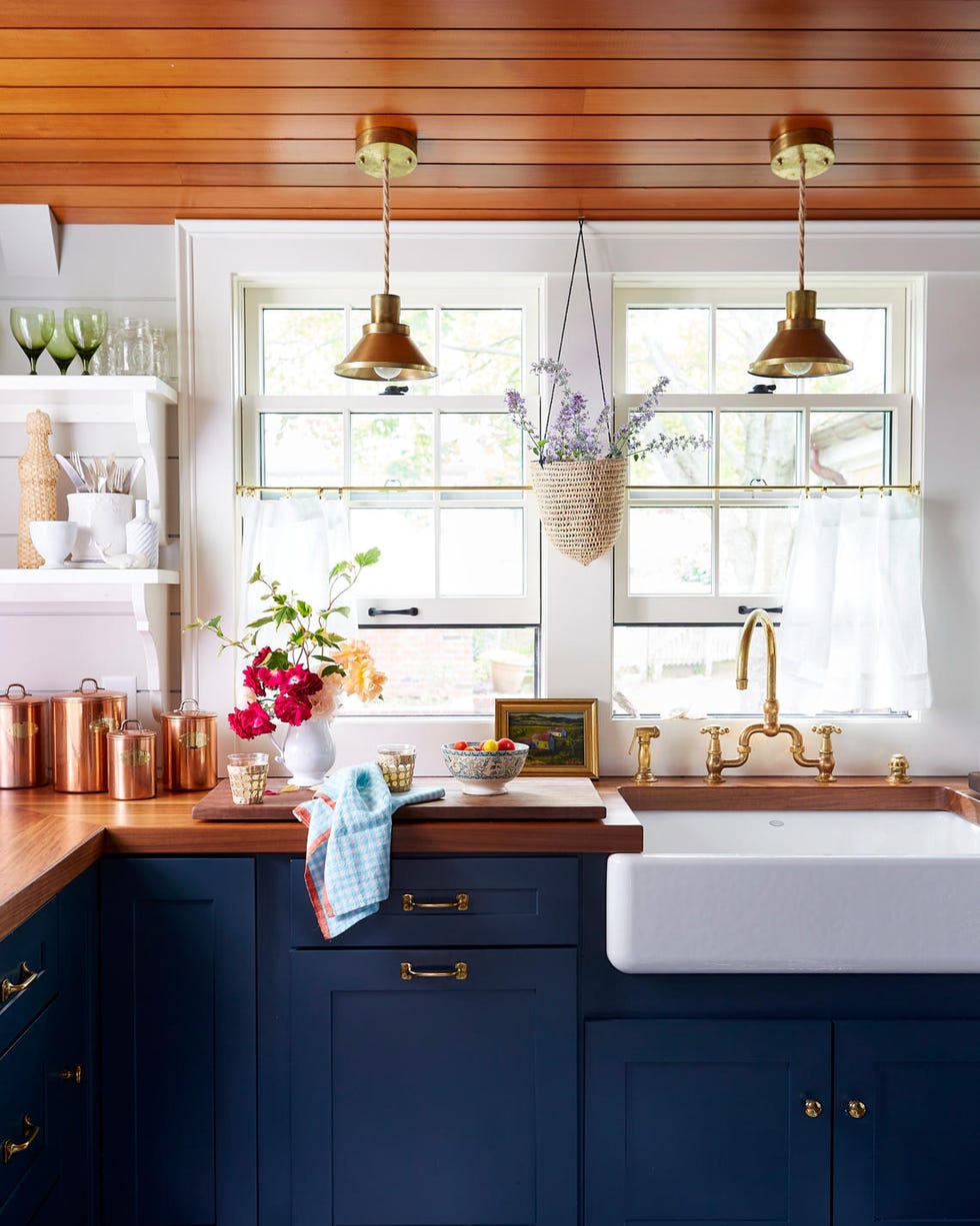 a kitchen with blue cabinets and butcher block countertop and wood ceiling a kitchen with blue cabinets and butcher block countertop and wood ceiling
