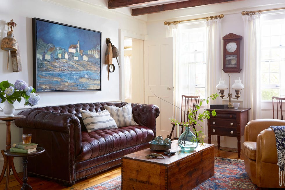 a living room with leather chesterfield sofa and a trunk coffee table a living room with leather chesterfield sofa and a trunk coffee table