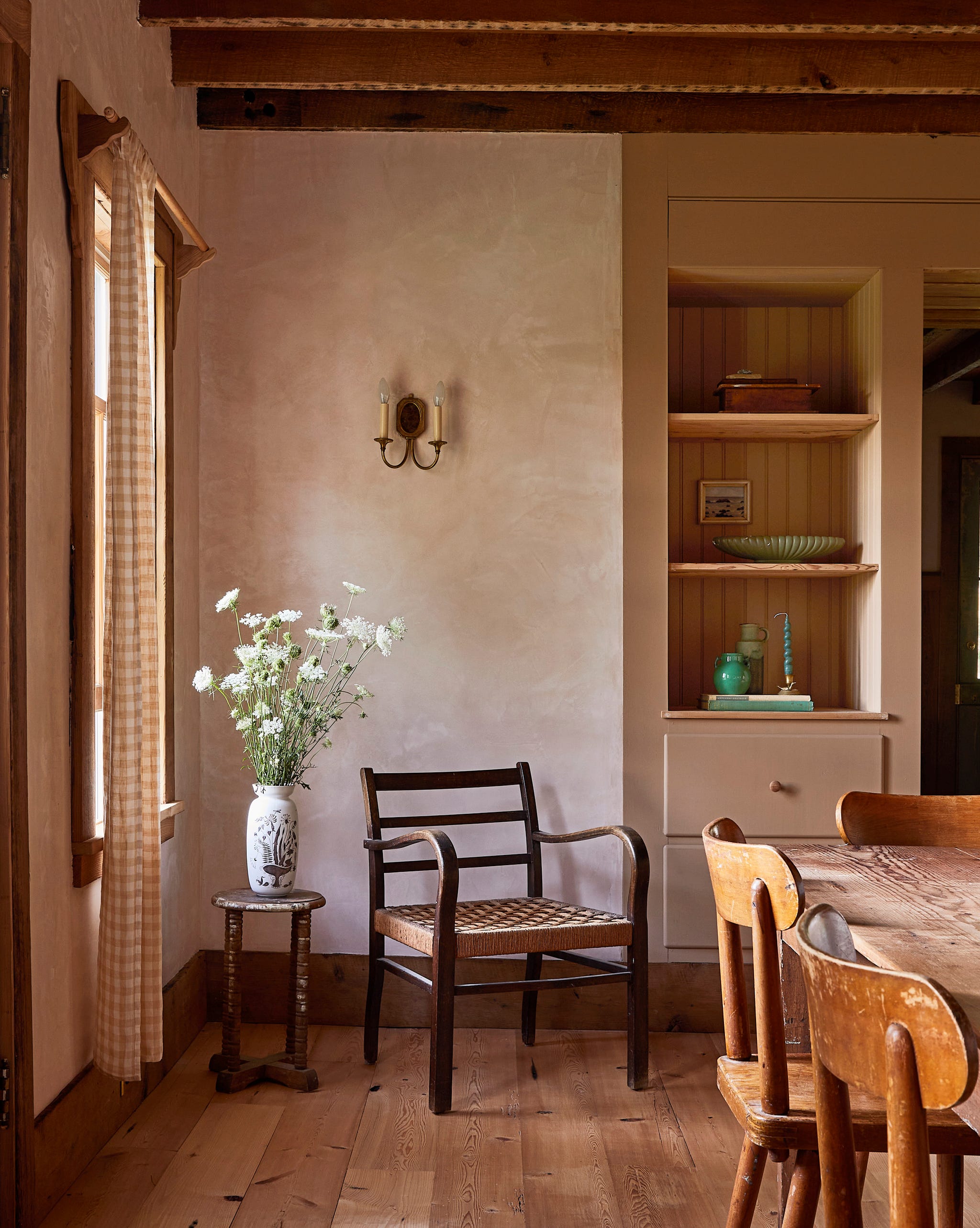 farmhouse dining room with built in shelves and a chair