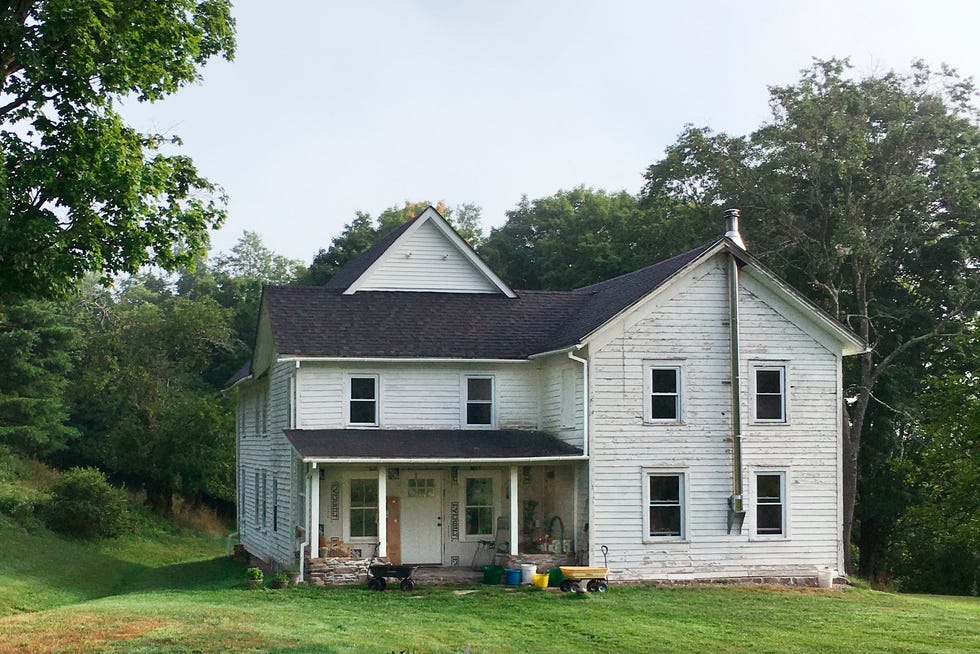 exterior of an old white farmhouse in new york