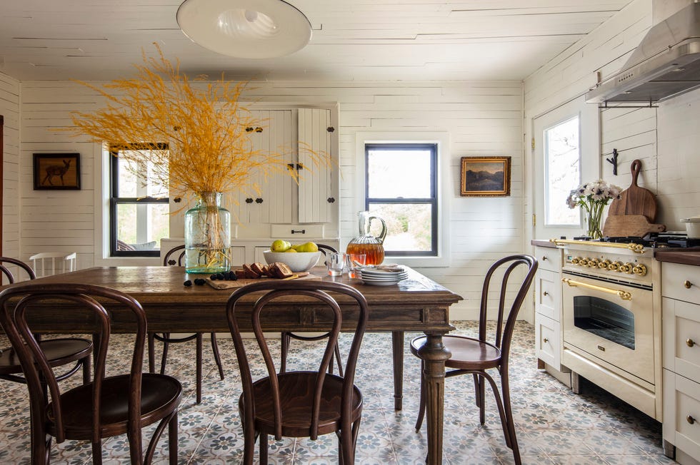 an white eat in farmhouse kitchen with tile floor