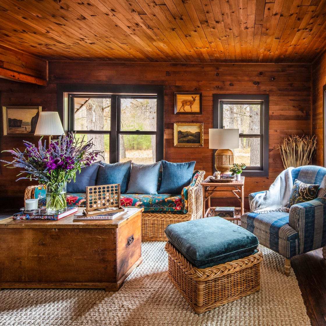 rustic farmhouse living room with wood walls and blue upholstery