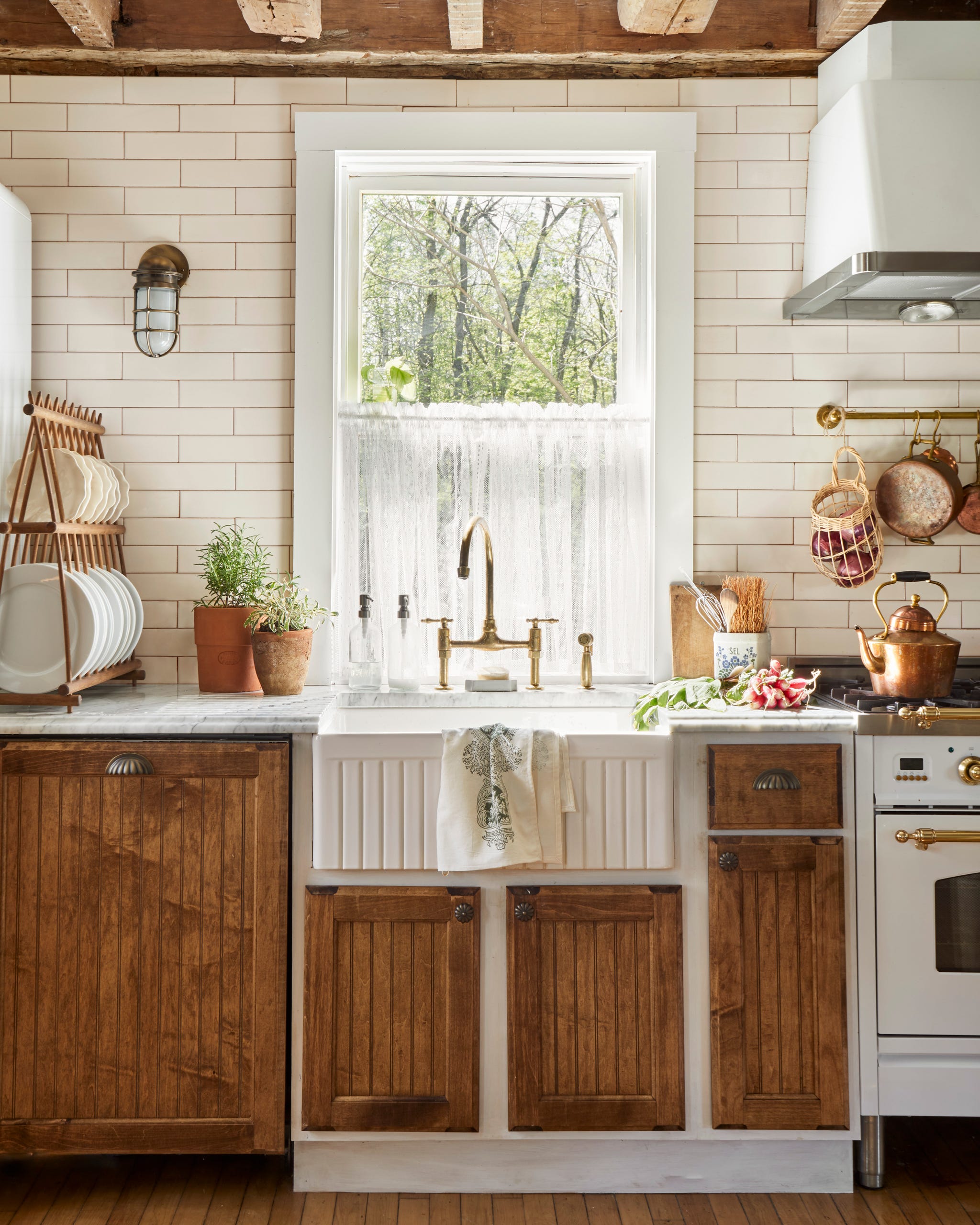 rustic kitchen with farmhouse sink in front of window