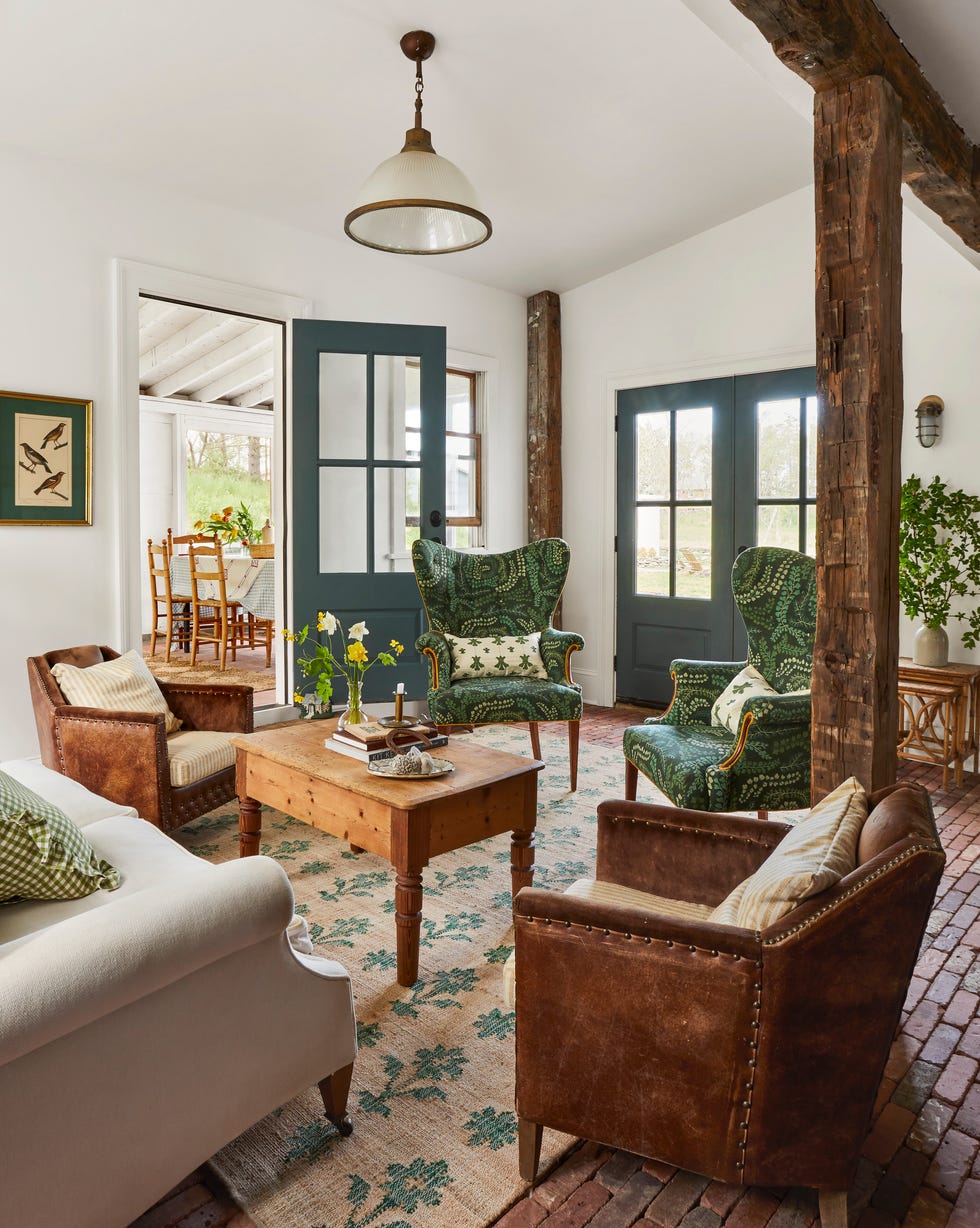 den with rug, leather and wingback chairs, and coffee table