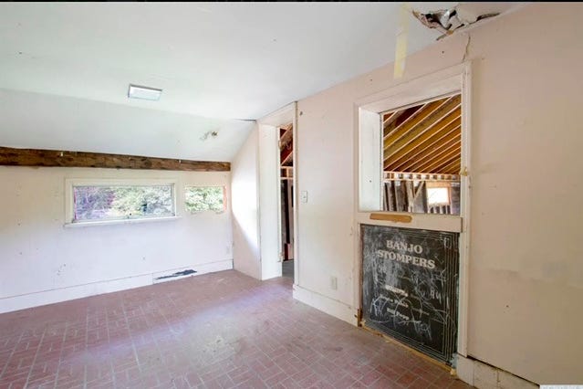 interior of a room with unfinished walls and a door labeled banjo stompers