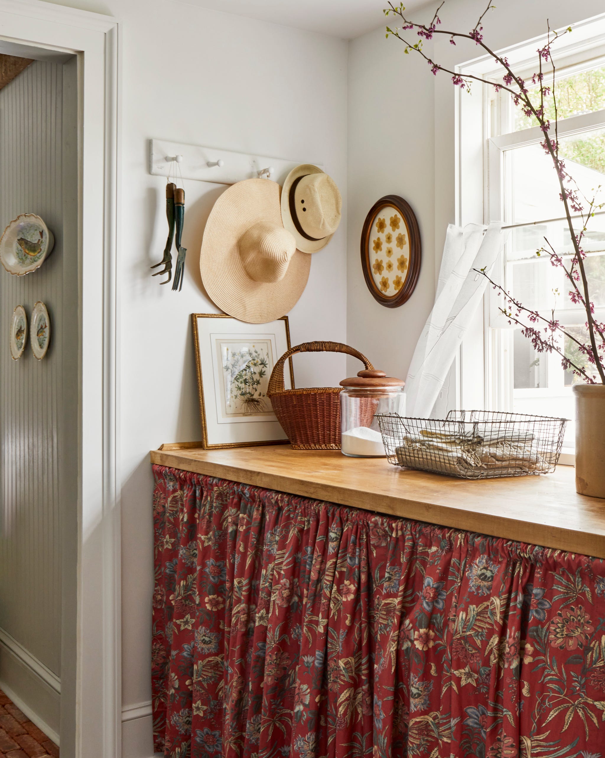 nook in hallway with a curtain over a washer and dryer and a shelf above them