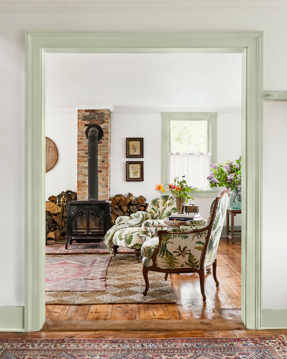 living room with chairs with a fern pattern and a wood burning stove