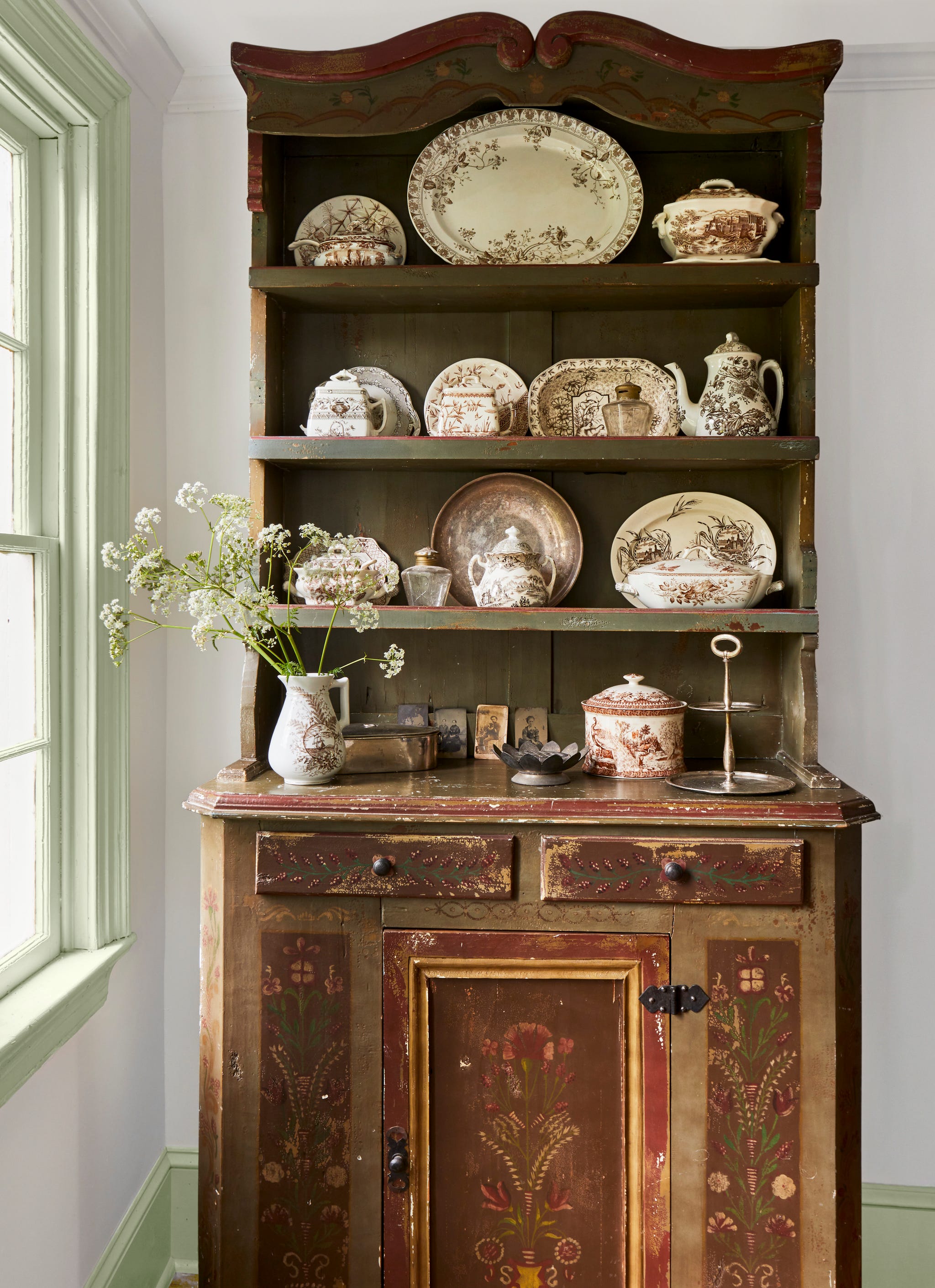 antique hutch with decorative plates on its shelves